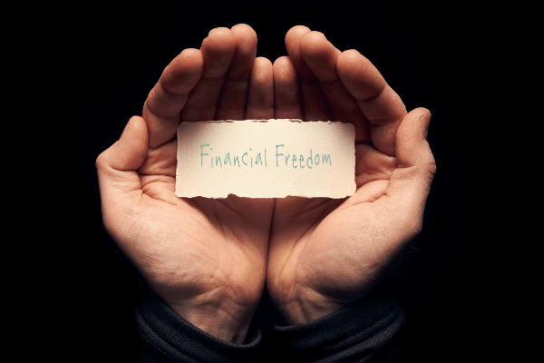 Two hands holding a card saying Financial Freedom